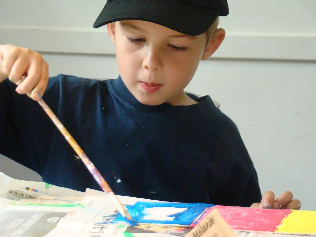 Petit garçon attentif lors d'un atelier créatif pour enfant